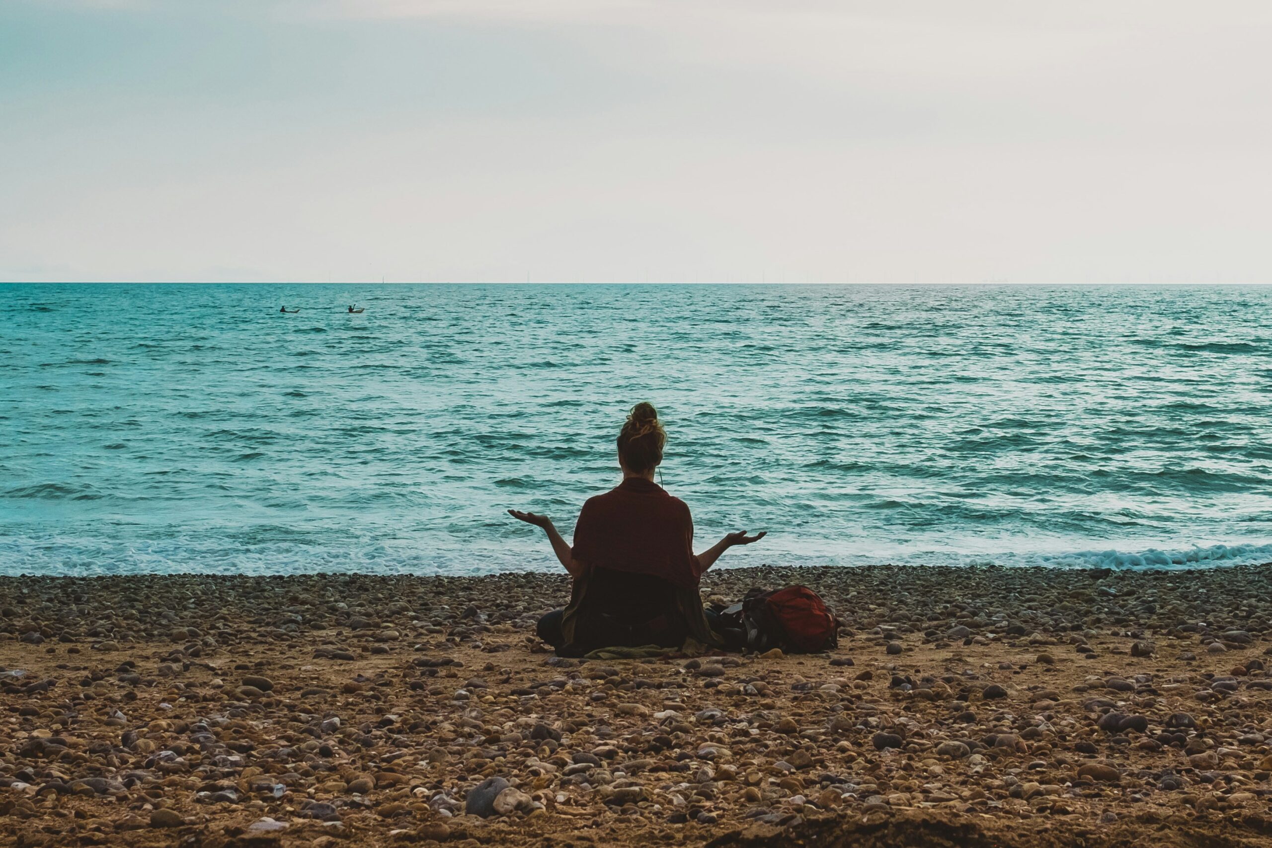 woman meditating beach